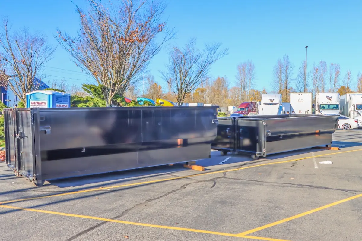 Professional dumpster rental service with roll-off container on residential driveway in Beckley